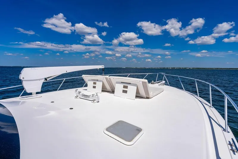 Slide: The Image of 2006 Viking 56 Convertible yacht deck with ocean view and clear blue sky. - 61
