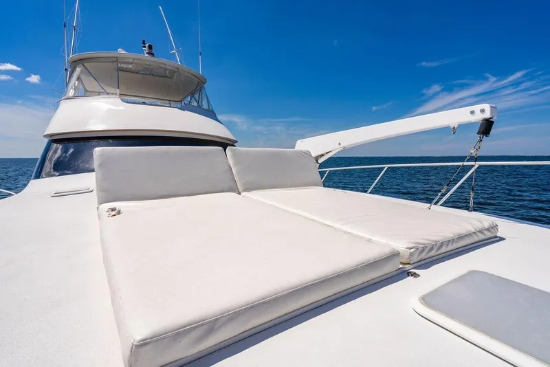 Slide: The Image of 2006 Viking 56 Convertible yacht with sun deck, cruising on open water. - 64