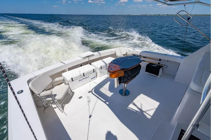 Slide: The Image of 2006 Viking 56 Convertible yacht deck with seating and ocean view. - 66