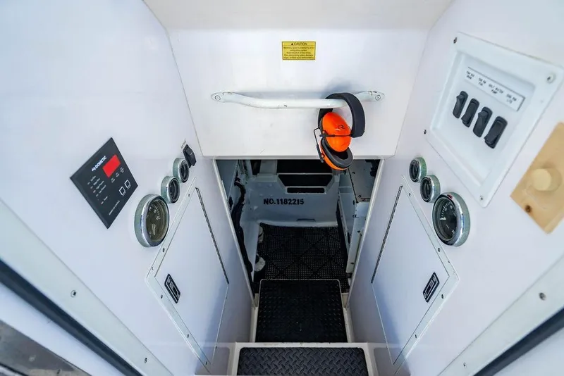 Slide: The Image of Engine room access of 2006 Viking 56 Convertible yacht with gauges and controls. - 69