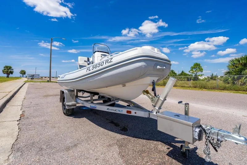 Slide: The Image of A 2006 Viking 56 Convertible boat on a trailer under a clear blue sky. - 79