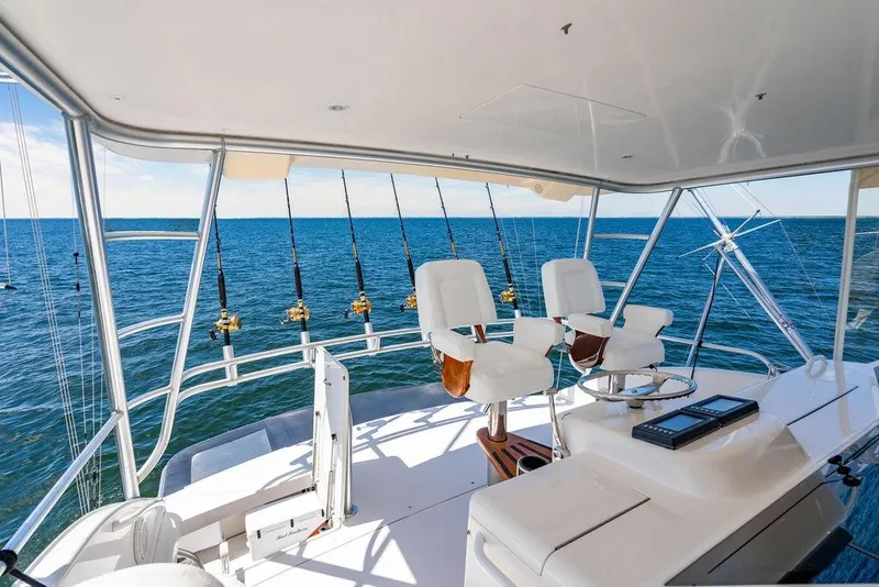 Slide: The Image of 2006 Viking 56 Convertible yacht interior with fishing rods and ocean view. - 8