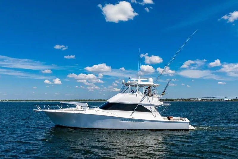 Slide: The Image of 2006 Viking 56 Convertible yacht cruising on a sunny day with blue skies. - 83