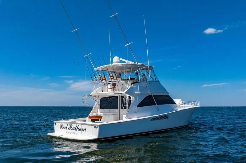 Slide: The Image of 2006 Viking 56 Convertible yacht on open water under clear blue sky. - 84