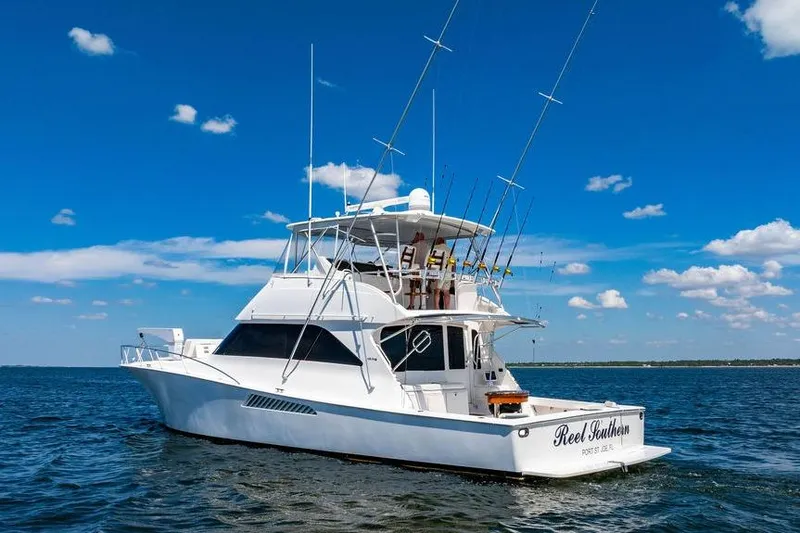 Slide: The Image of 2006 Viking 56 Convertible yacht on open water under clear blue sky. - 86
