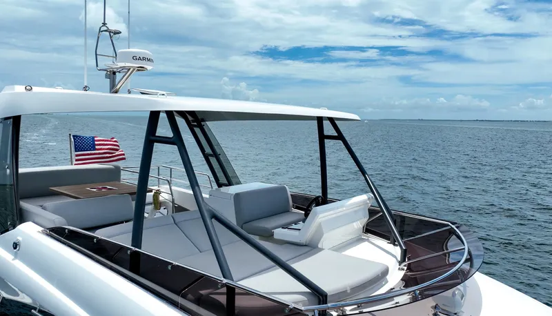 Slide: The Image of 2023 Prestige 520 yacht on open water, featuring sleek design and American flag. - 14