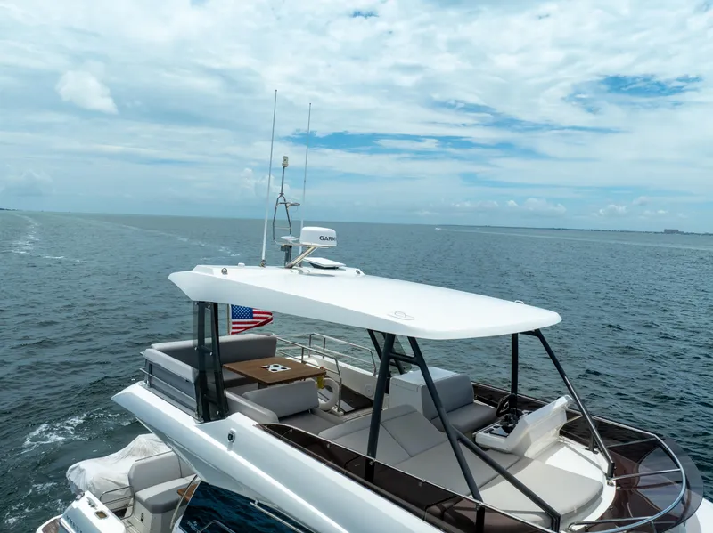Slide: The Image of Luxury 2023 Prestige 520 yacht cruising on open sea under clear skies. - 15