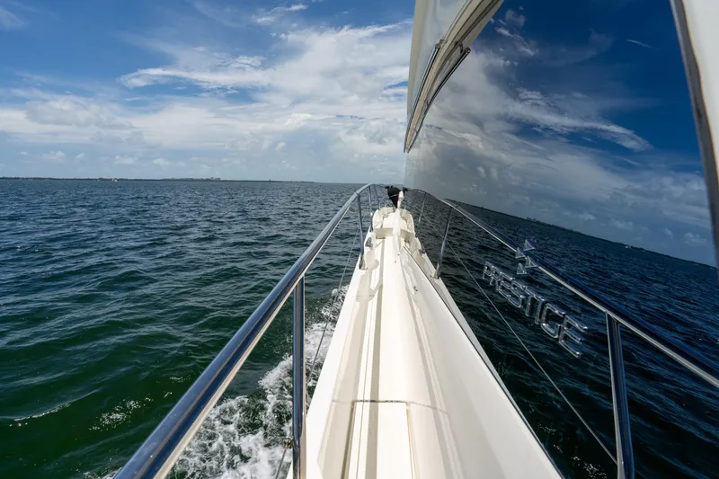 Slide: The Image of 2023 Prestige 520 yacht cruising on open sea under clear blue sky. - 16