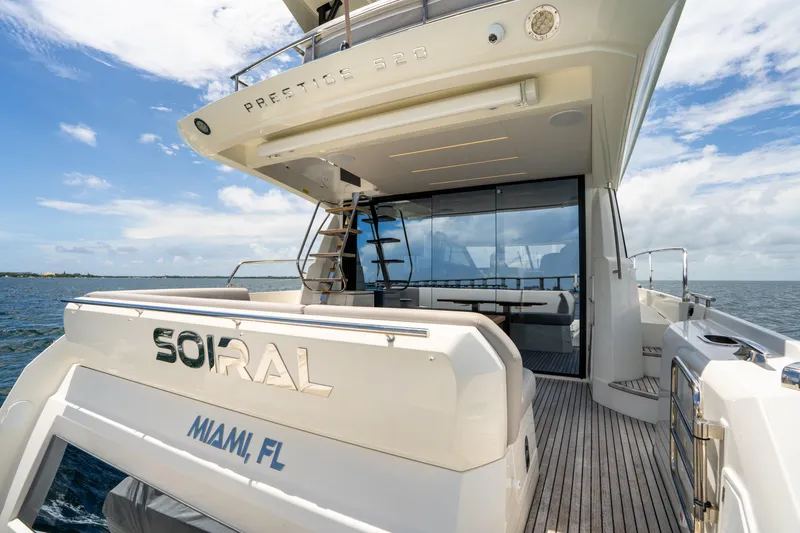 Slide: The Image of Luxury 2023 Prestige 520 yacht docked in Miami, featuring sleek design and spacious deck. - 24