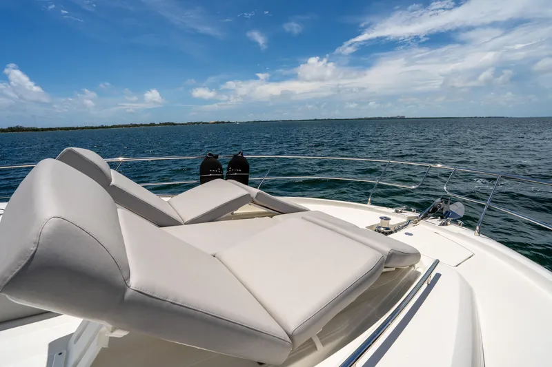Slide: The Image of Luxurious 2023 Prestige 520 yacht with sun loungers on open sea. - 29