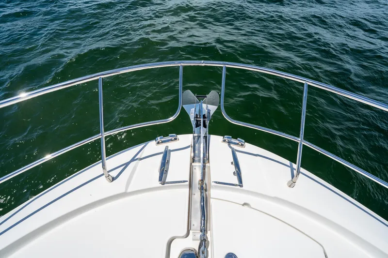 Slide: The Image of Bow of 2023 Prestige 520 yacht with stainless steel railings on open water. - 33