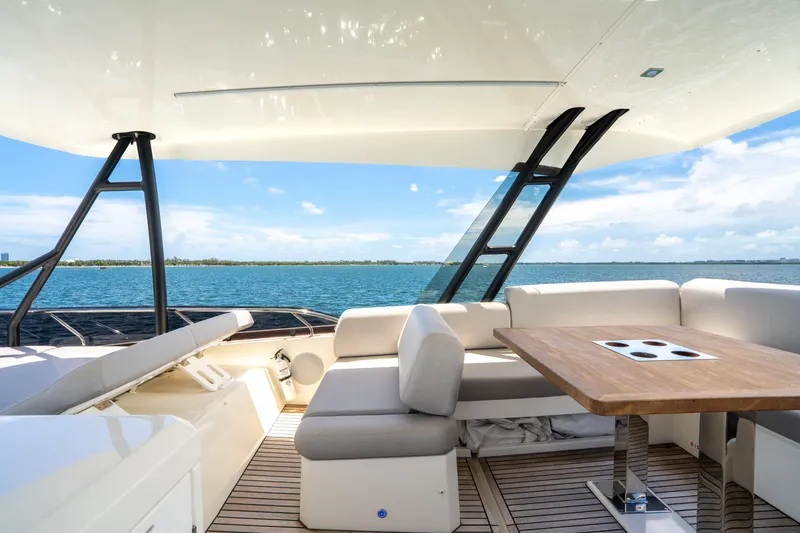 Slide: The Image of Luxurious 2023 Prestige 520 yacht interior with ocean view, featuring elegant seating and table. - 34