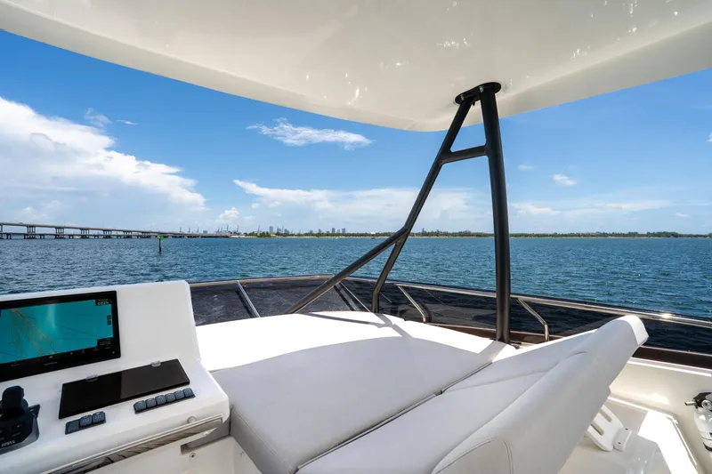 Slide: The Image of Luxury 2023 Prestige 520 yacht helm with ocean view and navigation system. - 39