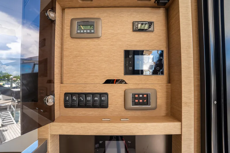 Slide: The Image of Control panel of a 2023 Prestige 520 yacht with various switches and displays. - 40