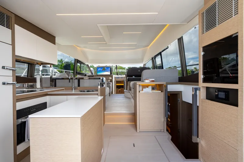 Slide: The Image of Luxurious interior of 2023 Prestige 520 yacht featuring modern kitchen and spacious seating area. - 41
