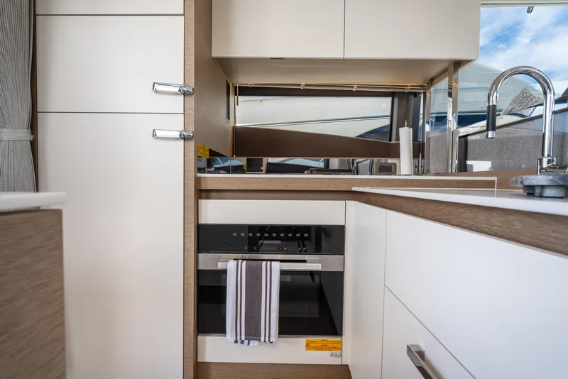 Slide: The Image of Modern kitchen interior of 2023 Prestige 520 yacht with sleek cabinetry and appliances. - 44