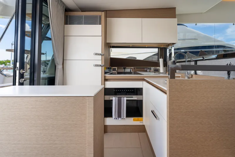 Slide: The Image of Modern kitchen interior on a 2023 Prestige 520 yacht, featuring sleek cabinetry and appliances. - 45
