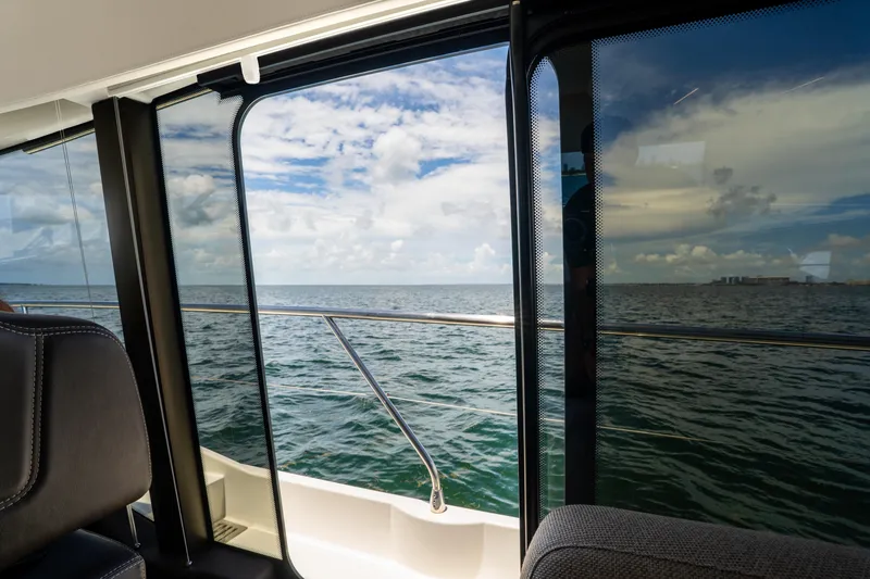Slide: The Image of View from Prestige 520 yacht window, overlooking ocean and cloudy sky, 2023 model. - 48