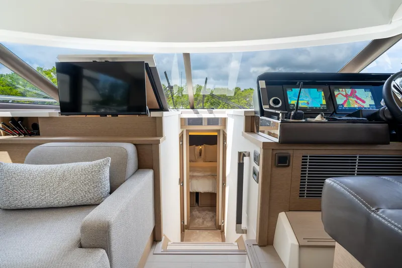 Slide: The Image of 2023 Prestige 520 yacht interior with modern navigation system and cozy seating area. - 49