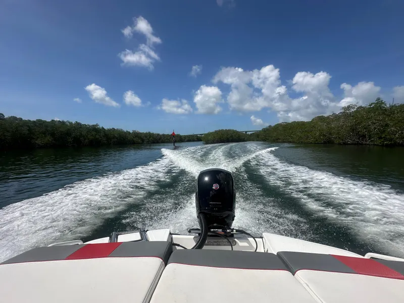 Slide: The Image of 2024 Tahoe T21 boat cruising on a sunny day, leaving a wake in the water. - 13