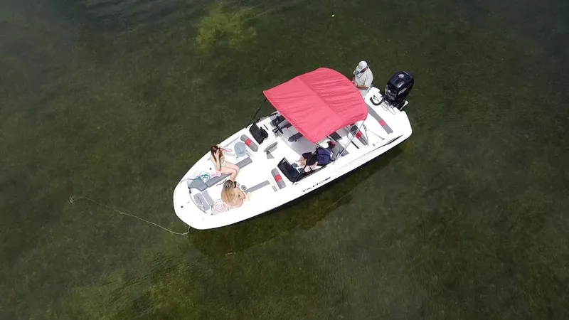 Slide: The Image of 2024 Tahoe T21 boat on calm water with passengers relaxing. - 3