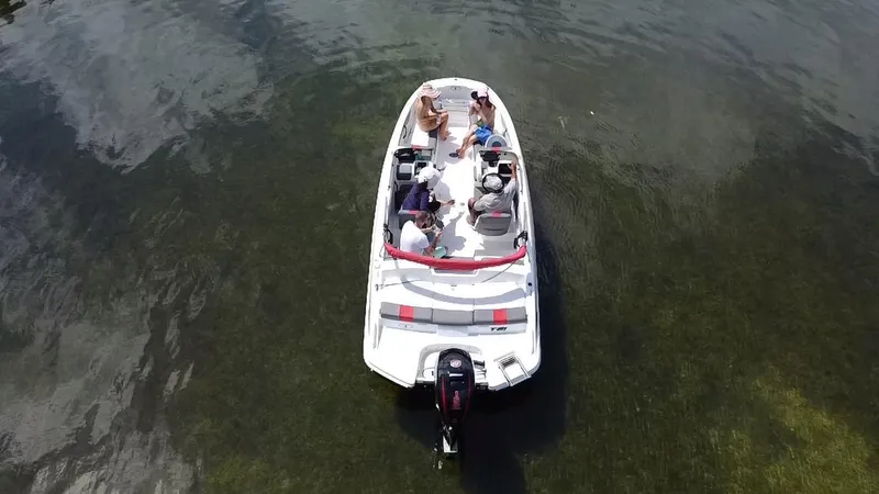 Slide: The Image of 2024 Tahoe T21 boat with passengers relaxing on calm water. - 6