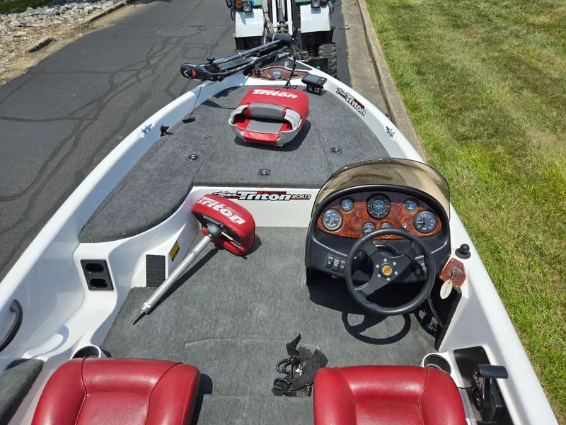 Slide: The Image of 1998 Triton Tr-17 boat interior with red seats and detailed dashboard. - 13