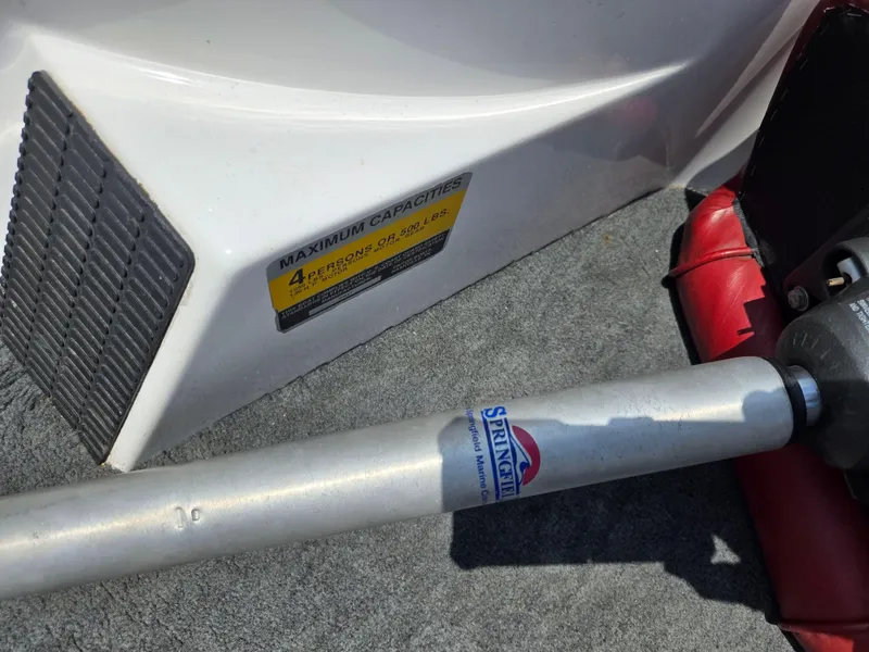 Slide: The Image of 1998 Triton Tr-17 boat capacity label and Springfield marine equipment. - 15