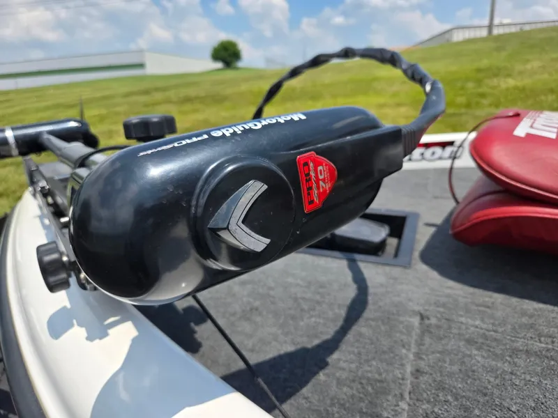 Slide: The Image of Triton Tr-17 boat with Minn Kota trolling motor, 1998 model, on grassy landscape. - 7