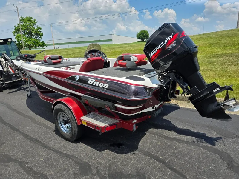 Slide: The Image of 1998 Triton Tr-17 boat with Mercury engine on a trailer, parked outdoors. - 8