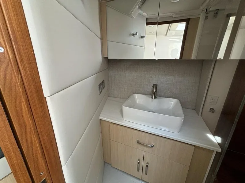 Slide: The Image of Modern bathroom in 2025 Regal 36 XO yacht with sleek sink and cabinetry. - 45