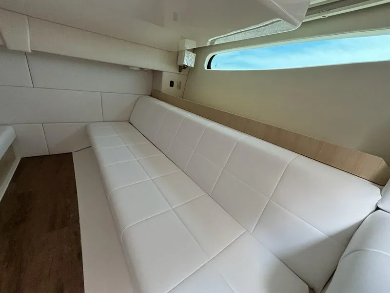 Slide: The Image of Luxurious interior of 2025 Regal 36 XO yacht with white seating and wood accents. - 47