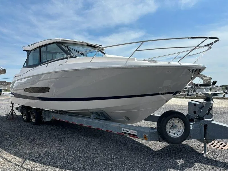 Slide: The Image of 2025 Regal 36 XO boat on trailer under clear blue sky. - 5