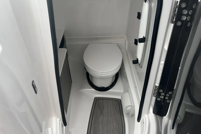 Slide: The Image of Compact bathroom in 2026 Monterey M-65 boat, featuring a modern toilet and sleek design. - 10