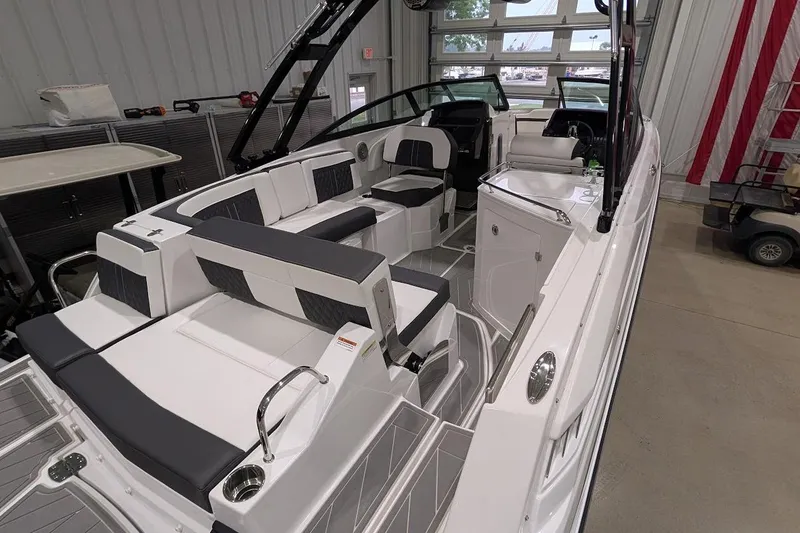 Slide: The Image of 2026 Monterey M-65 boat interior with sleek seating and modern design in a showroom. - 3