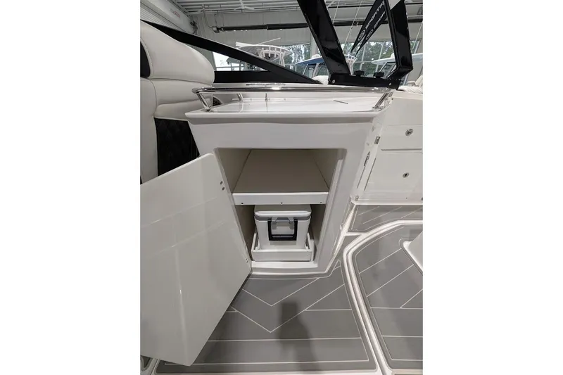 Slide: The Image of 2026 Monterey M-65 boat interior with open storage compartment and modern design. - 12