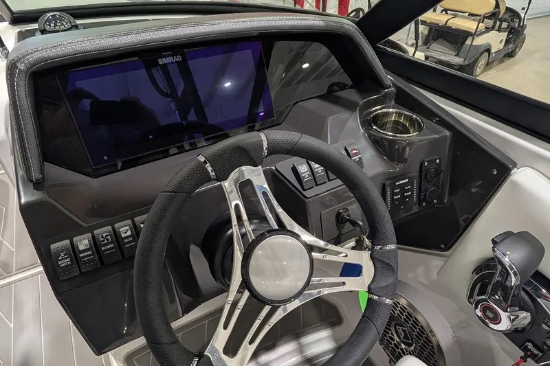 Slide: The Image of 2026 Monterey M-65 boat dashboard with steering wheel and control panel. - 16