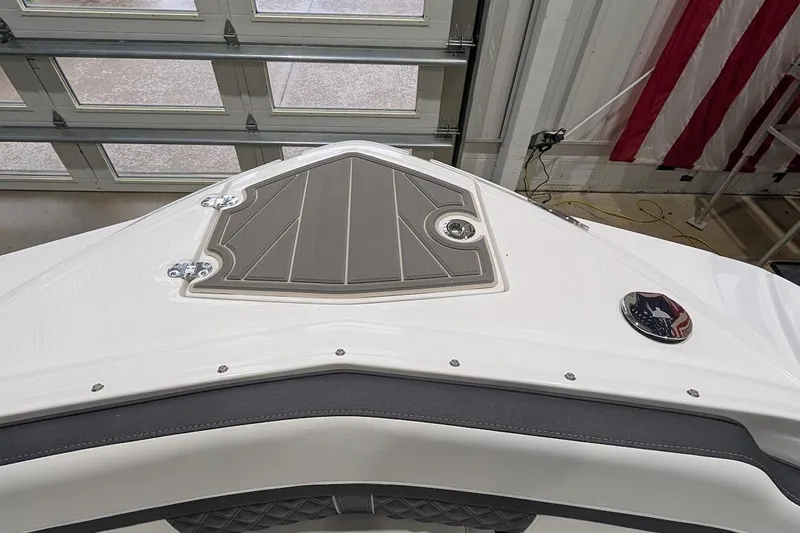 Slide: The Image of 2026 Monterey M-65 boat bow with sleek design in a garage setting. - 25