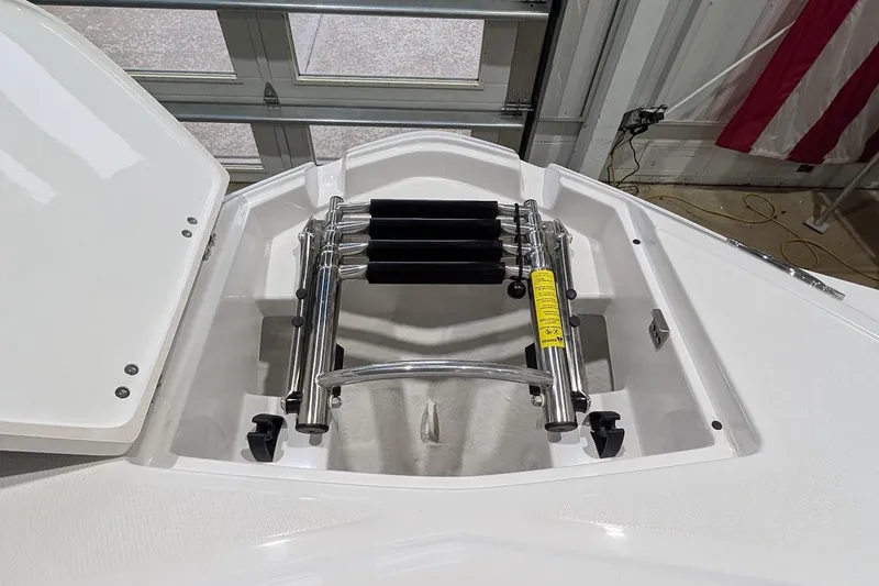 Slide: The Image of 2026 Monterey M-65 boat ladder compartment with stainless steel retractable ladder. - 26