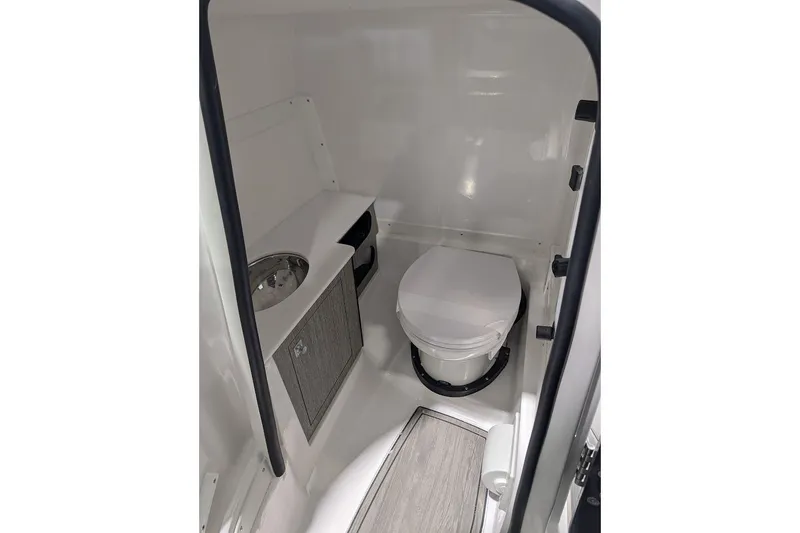 Slide: The Image of 2026 Monterey M-65 boat interior bathroom with toilet and sink. - 18