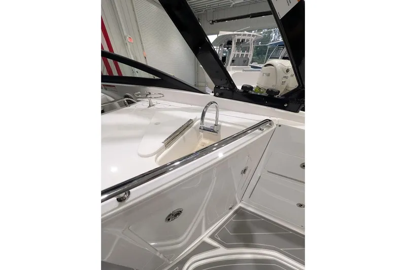 Slide: The Image of Interior view of a 2026 Monterey M-65 boat featuring a sleek sink and storage area. - 11