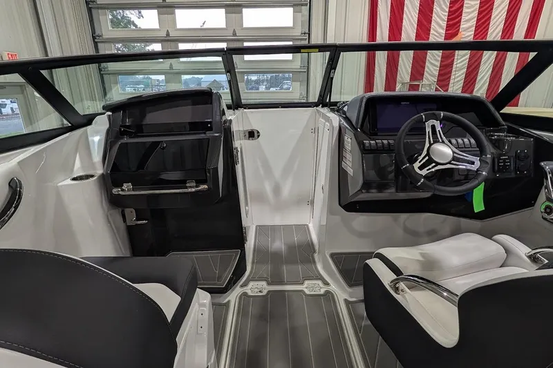 Slide: The Image of 2026 Monterey M-65 boat interior with modern dashboard and steering wheel in a showroom. - 20