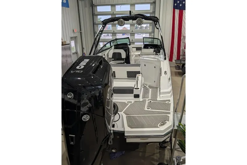 Slide: The Image of 2026 Monterey M-65 boat with powerful engine, sleek design, and spacious deck in showroom. - 2