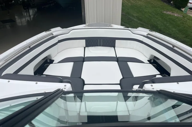 Slide: The Image of 2026 Monterey M-65 boat interior with white and black cushioned seating. - 6