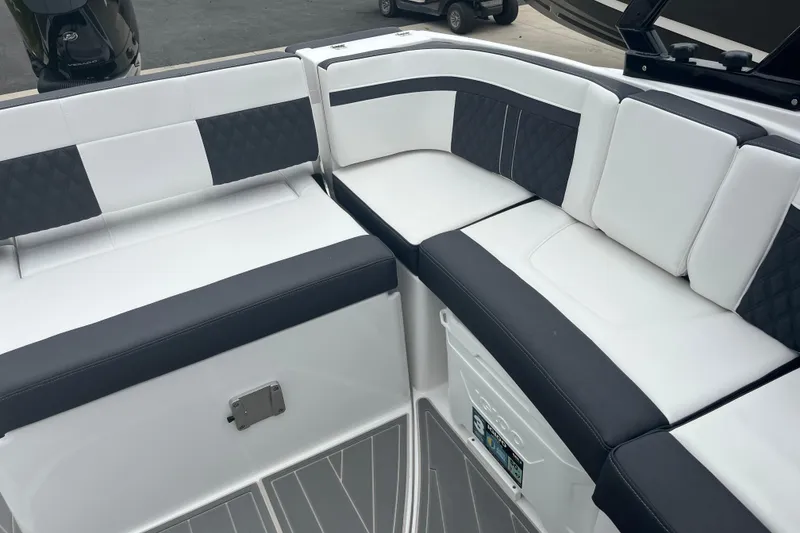 Slide: The Image of 2026 Monterey M-65 boat interior with white and black cushioned seating. - 7
