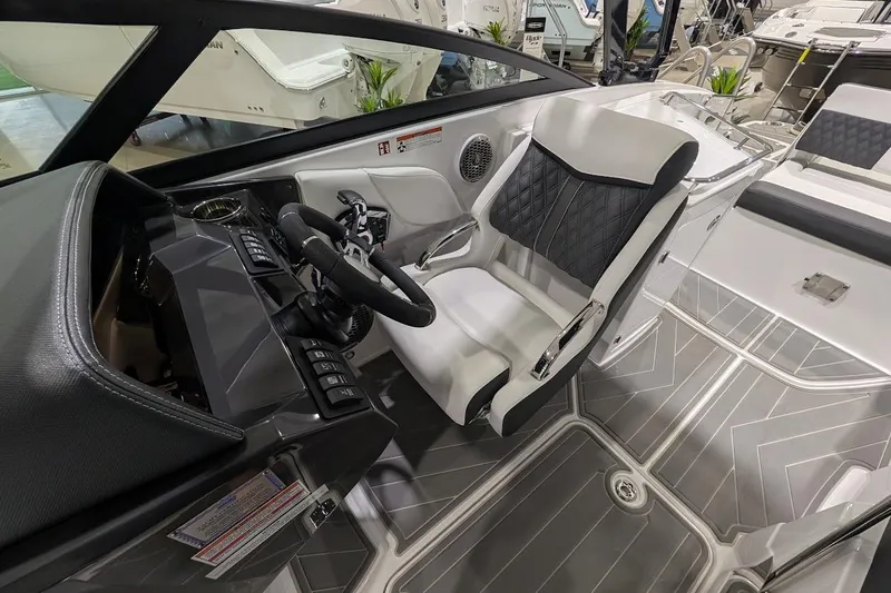 Slide: The Image of Interior of 2026 Monterey M-65 boat featuring sleek helm and modern seating design. - 15