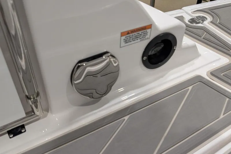 Slide: The Image of 2026 Monterey M-65 boat deck with chrome fittings and warning label. - 31