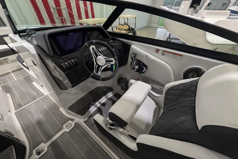 Slide: The Image of Interior of a 2026 Monterey M-65 boat, featuring a sleek helm and modern controls. - 14