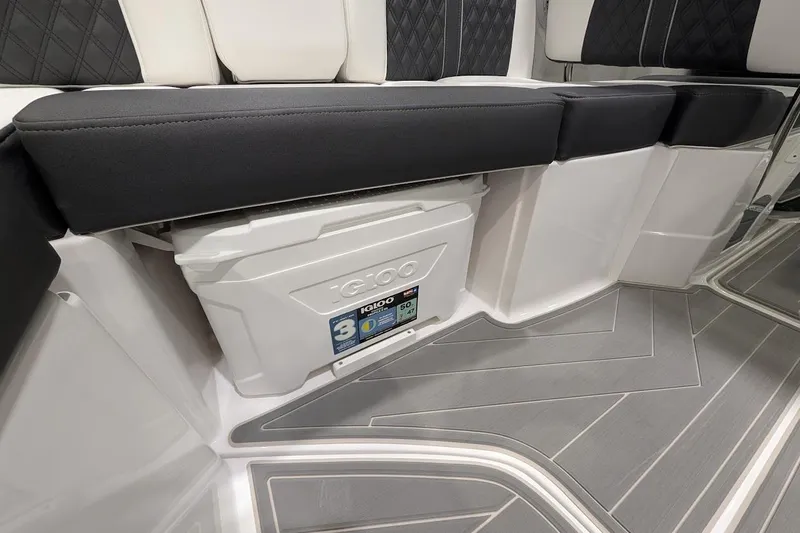 Slide: The Image of 2026 Monterey M-65 boat interior with Igloo cooler storage under cushioned seating. - 13