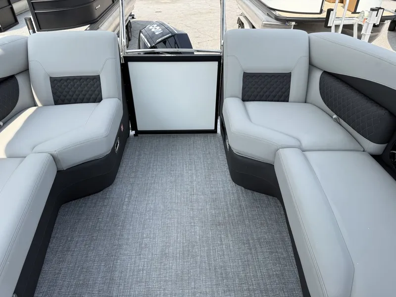 Slide: The Image of Interior of a 2026 Harris Sunliner 230 with gray upholstered seating and carpeted floor. - 13